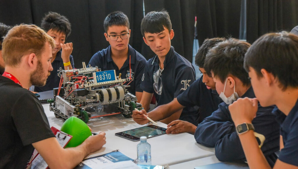 Students looking at robotics parts