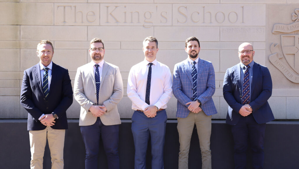 Boarding housemasters standing in suits