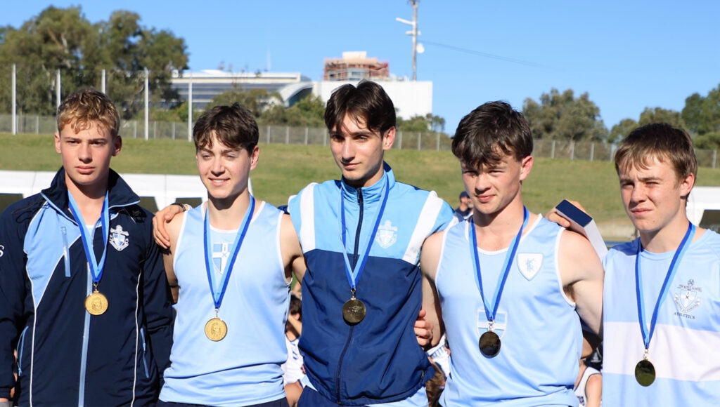 King's school boys standing in a line with medals around their necks